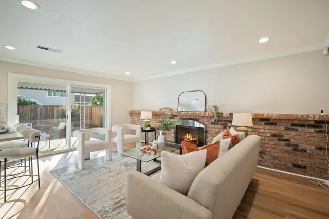 a living room with furniture a fireplace and a table