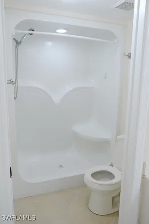 a bathroom with a shower and a toilet