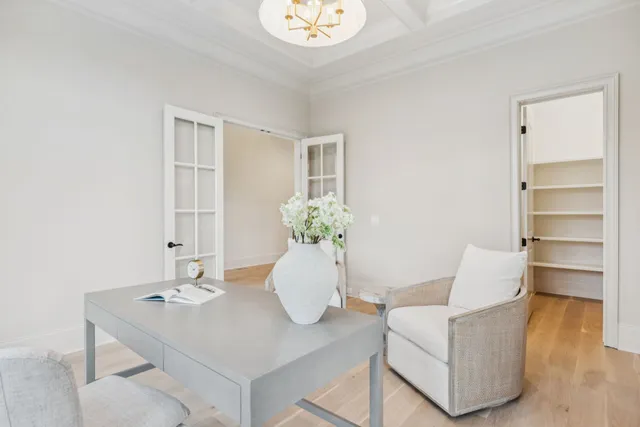 a living room with furniture a fireplace and a chandelier