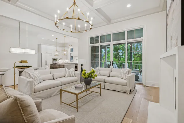 a living room with furniture and a chandelier