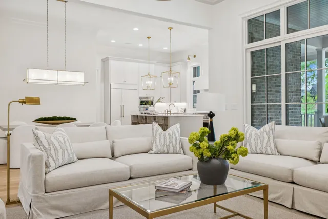 a large kitchen with granite countertop a stove a sink a dining table and chairs