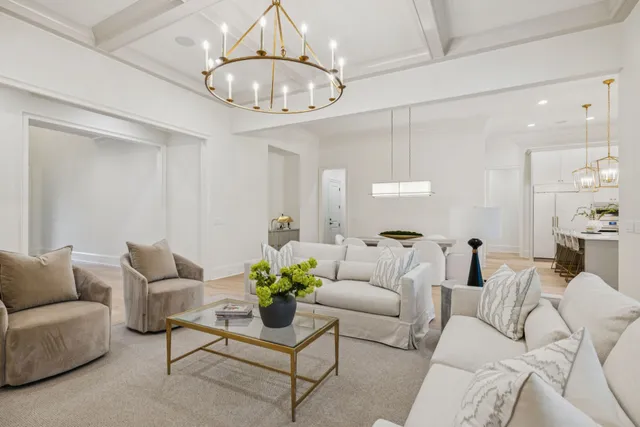 a bed sitting in a spacious bedroom next to a window