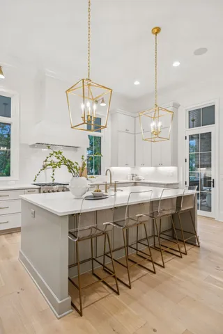 a view of a big house with a big yard and large trees