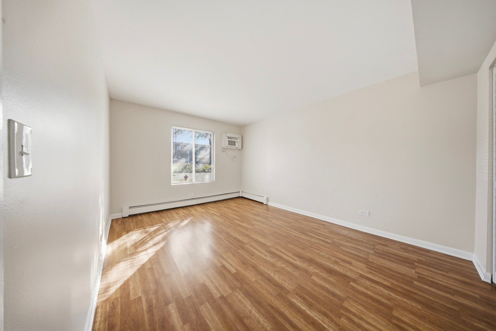 291 North Gregory Street, Unit 6 Aurora, IL 60504 - Photo 15 of 27 a view of an empty room and wooden floor and a window