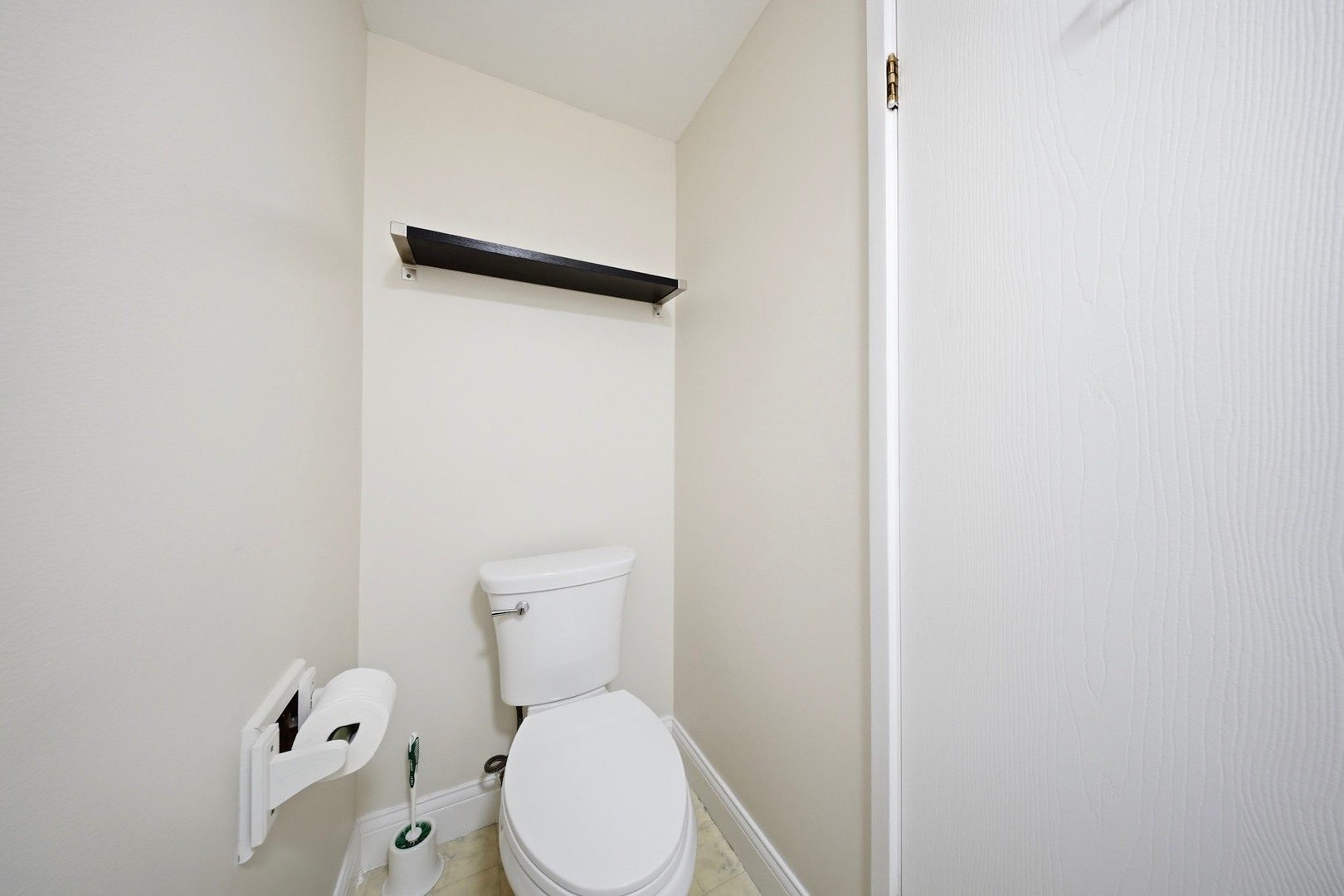 291 North Gregory Street, Unit 6 Aurora, IL 60504 - Photo 21 of 27 a white toilet sitting next to a white wall