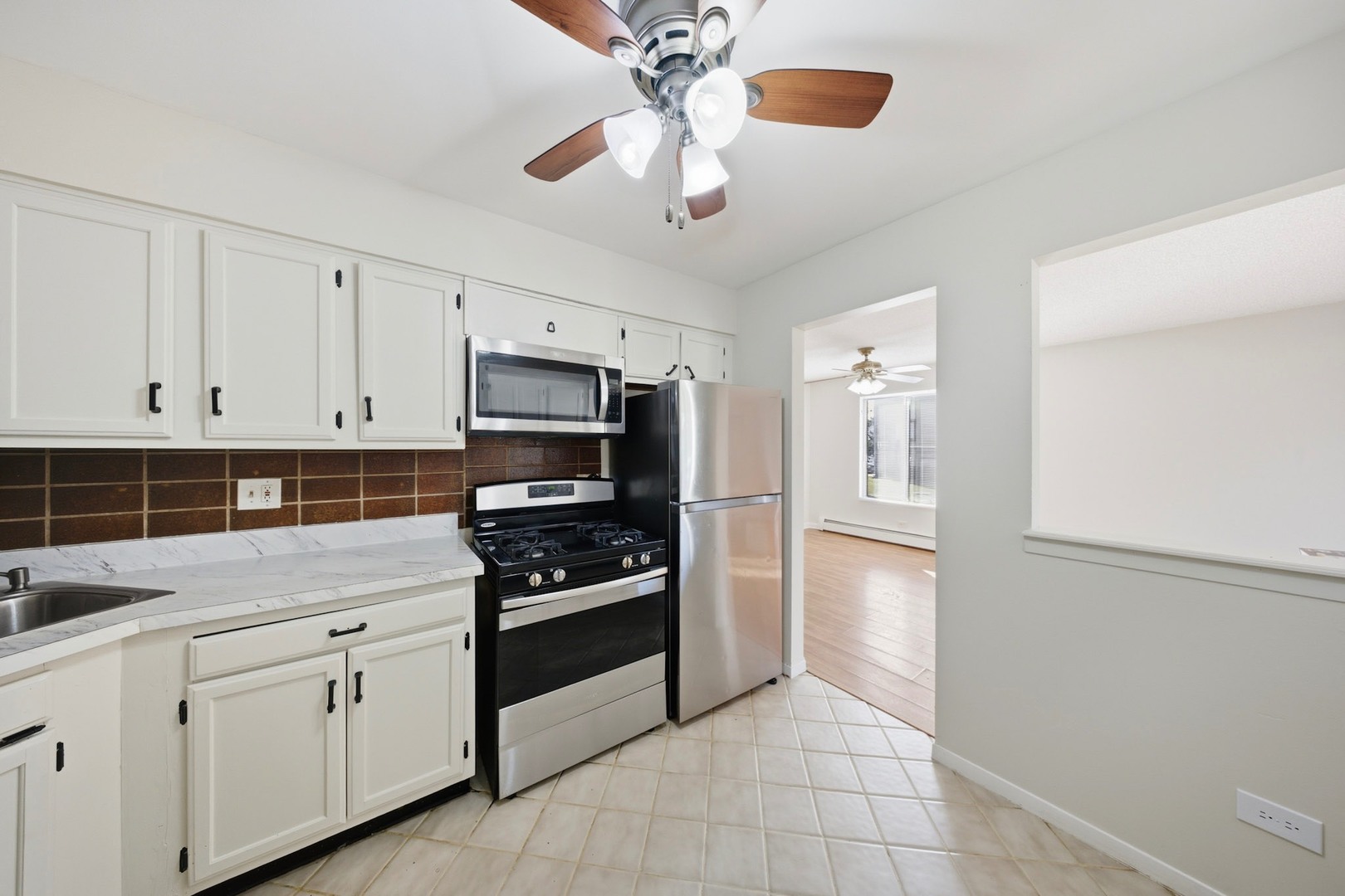 291 North Gregory Street, Unit 6 Aurora, IL 60504 - Photo 5 of 27 a kitchen with stainless steel appliances a stove refrigerator and cabinets