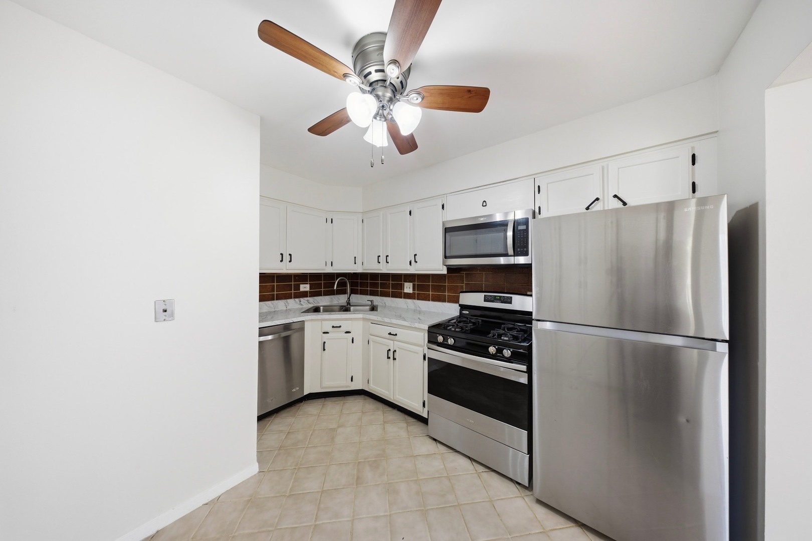 291 North Gregory Street, Unit 6 Aurora, IL 60504 - Photo 7 of 27 a kitchen with cabinets stainless steel appliances and a chandelier