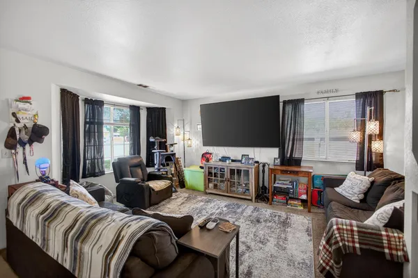 a living room with furniture and a flat screen tv