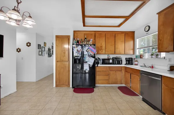 a kitchen with stainless steel appliances granite countertop a refrigerator and a sink