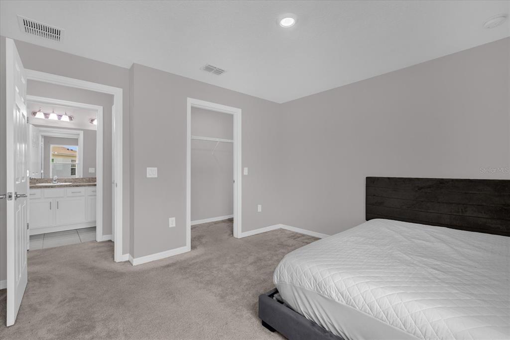 3470 Beau Road Kissimmee, FL 34746 - Photo 28 of 40 a bedroom with a bed and glass door