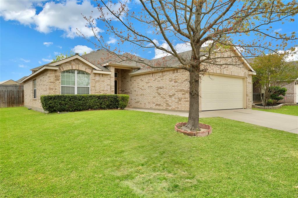 Ranch-style home featuring an attached garage, concrete driveway, and brick siding
