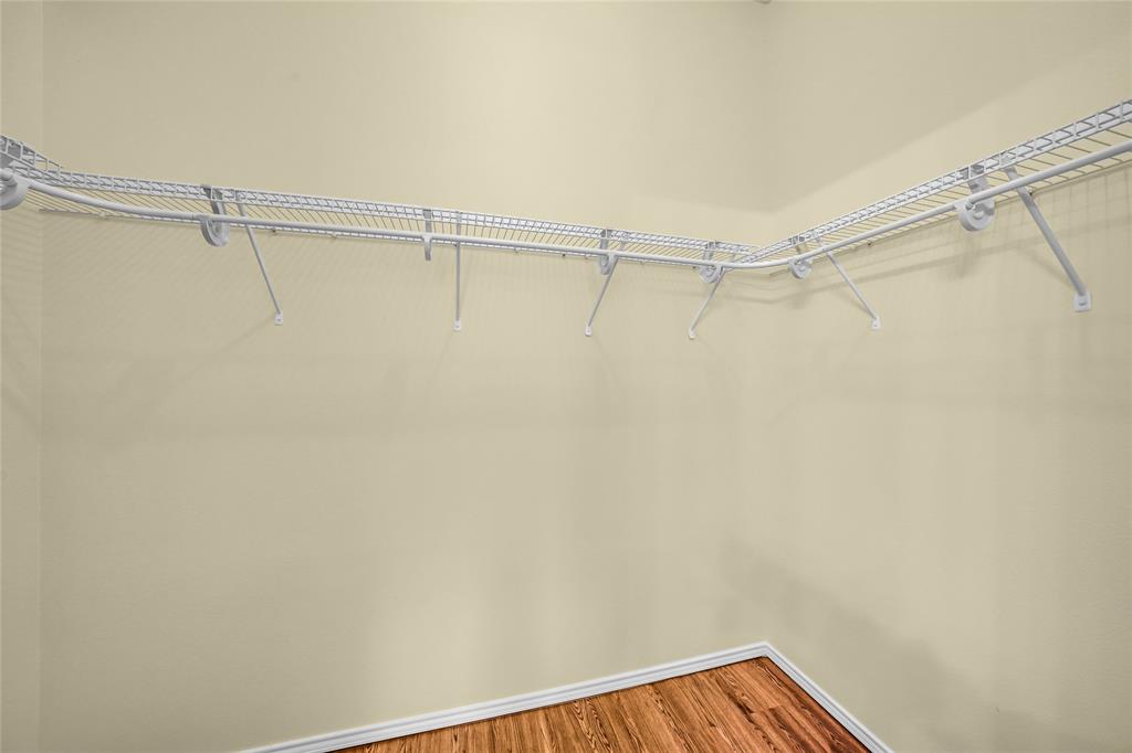 705 Loftin Street Crowley, TX 76036 - Photo 22 of 31 Walk in closet featuring wood finished floors