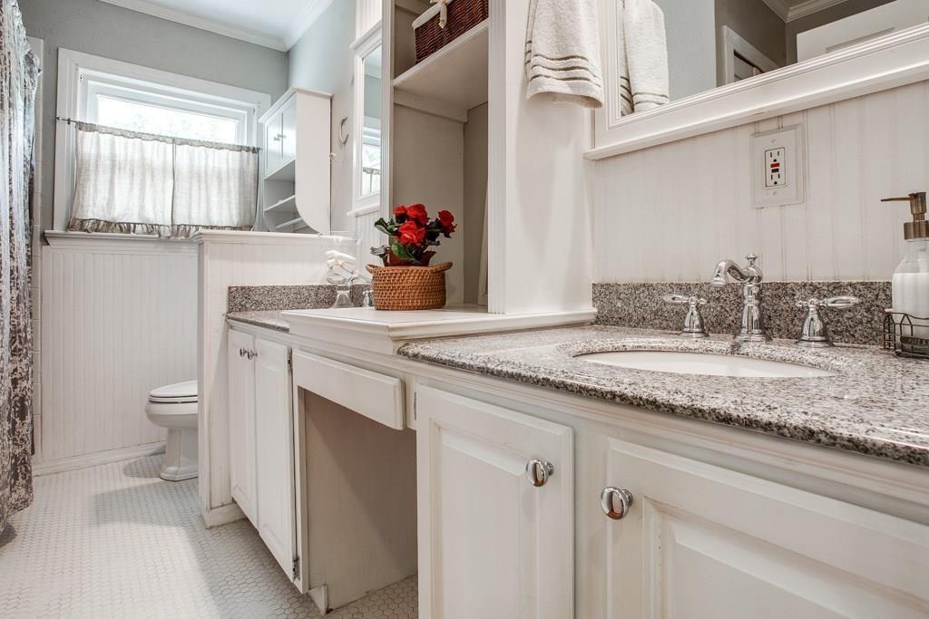6043 Llano Avenue Dallas, TX 75206 - Photo 19 of 40 a bathroom with a granite countertop sink and a toilet