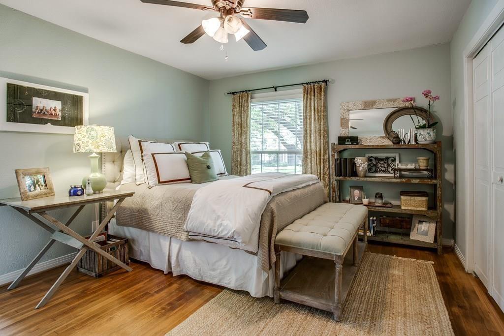 6043 Llano Avenue Dallas, TX 75206 - Photo 22 of 40 a bedroom with a bed and wooden floor