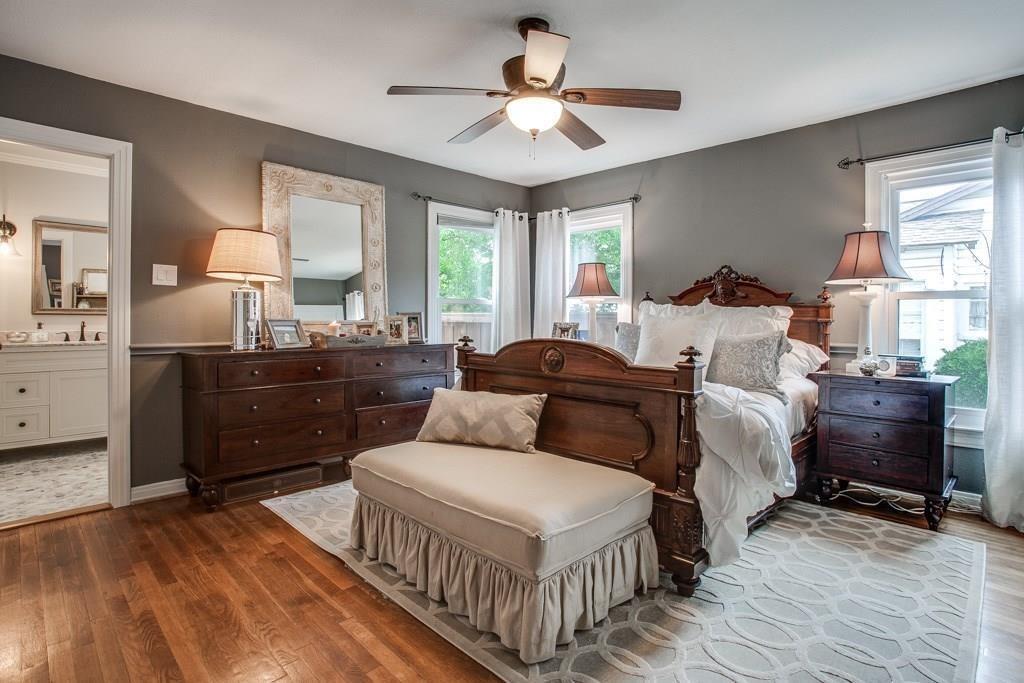 6043 Llano Avenue Dallas, TX 75206 - Photo 25 of 40 a bedroom with a bed and a chandelier