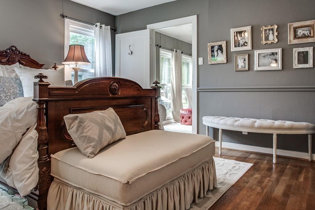 6043 Llano Avenue Dallas, TX 75206 - Photo 26 of 40 a bedroom with a bed and wooden floor