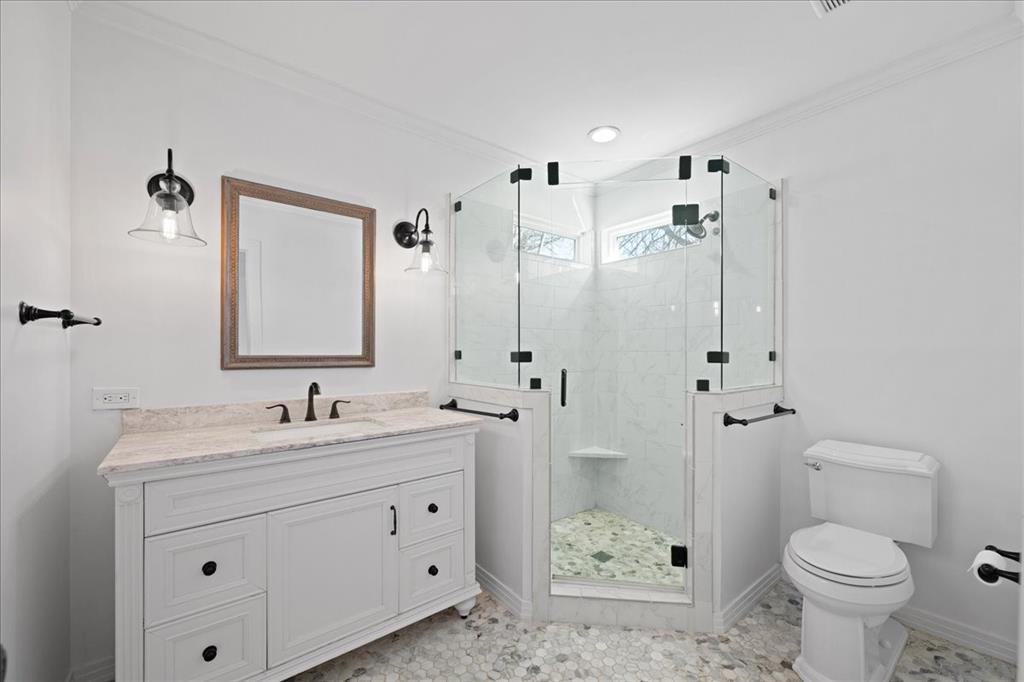 6043 Llano Avenue Dallas, TX 75206 - Photo 30 of 40 a bathroom with a double vanity sink toilet and shower