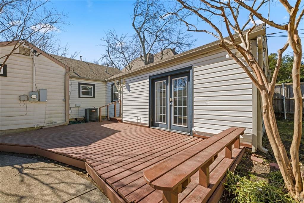6043 Llano Avenue Dallas, TX 75206 - Photo 33 of 40 a backyard of a house with wooden fence table and chairs