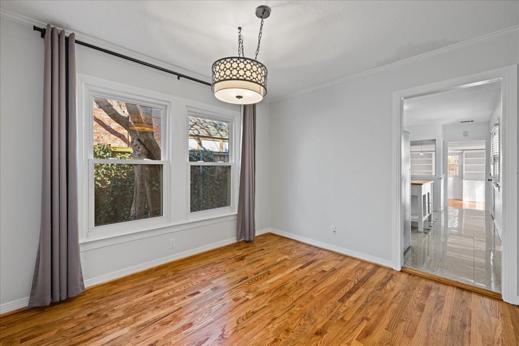 6043 Llano Avenue Dallas, TX 75206 - Photo 8 of 40 a view of an empty room with wooden floor and a window
