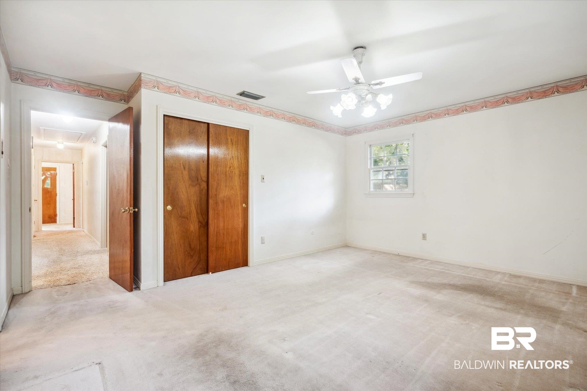 1252 Helm Circle Mobile, AL 36693 - Photo 10 of 18 Unfurnished bedroom with a closet, ceiling fan, and light colored carpet