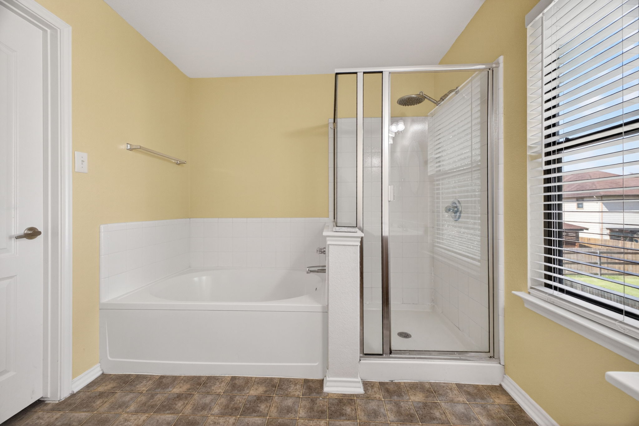 8813 Wiley Way Austin, TX 78747 - Photo 21 of 39 Primary bathroom with walk-in shower with glass doors and separate soaking tub