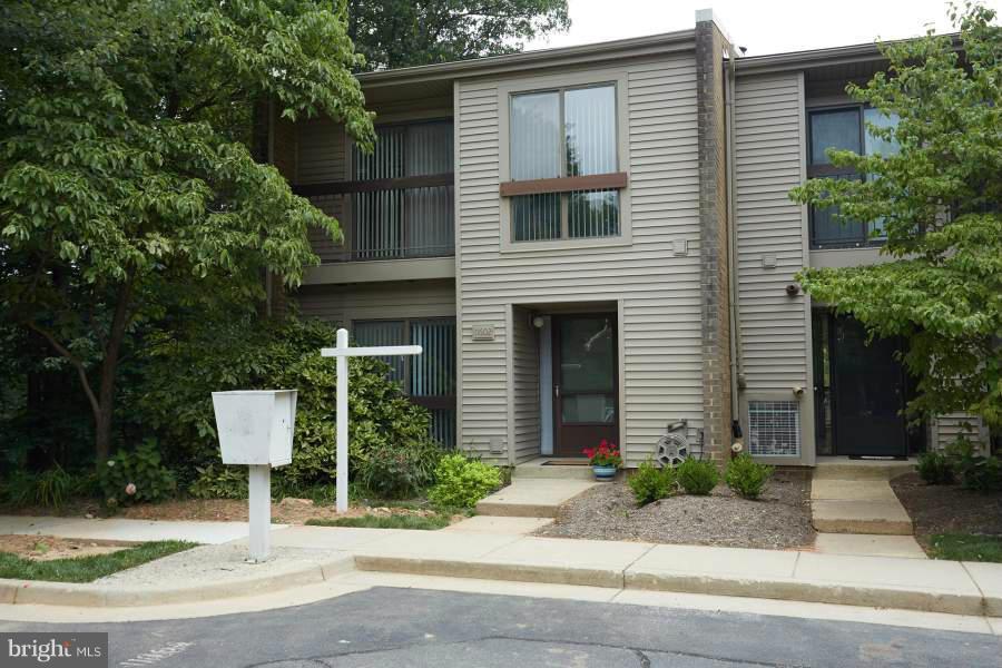11602 Windbluff Court, Unit 8A1 Reston, VA 20191 - Photo 1 of 27 a front view of a house with garden