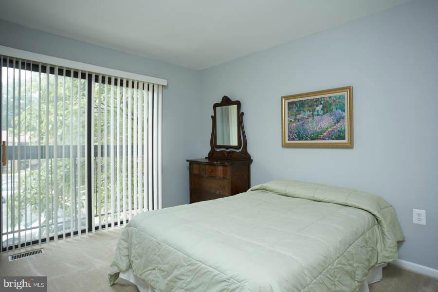 11602 Windbluff Court, Unit 8A1 Reston, VA 20191 - Photo 20 of 27 a bedroom with a large bed and a window