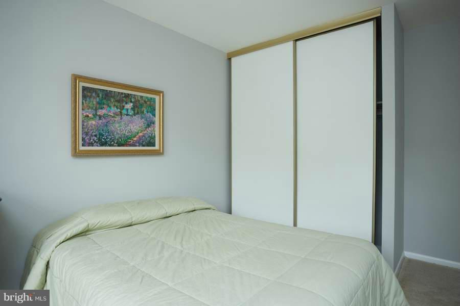 11602 Windbluff Court, Unit 8A1 Reston, VA 20191 - Photo 21 of 27 a bedroom with a bed and a painting on the wall