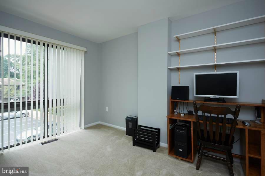 11602 Windbluff Court, Unit 8A1 Reston, VA 20191 - Photo 22 of 27 a living room with furniture and a flat screen tv