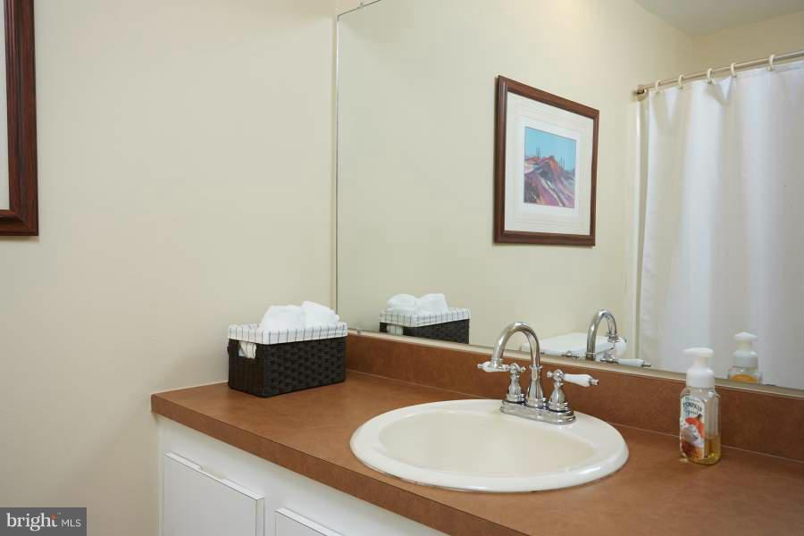 11602 Windbluff Court, Unit 8A1 Reston, VA 20191 - Photo 24 of 27 a bathroom with a sink and a mirror