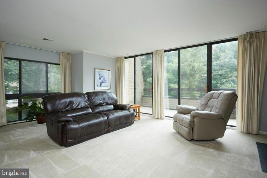 11602 Windbluff Court, Unit 8A1 Reston, VA 20191 - Photo 4 of 27 a living room with furniture and a large window