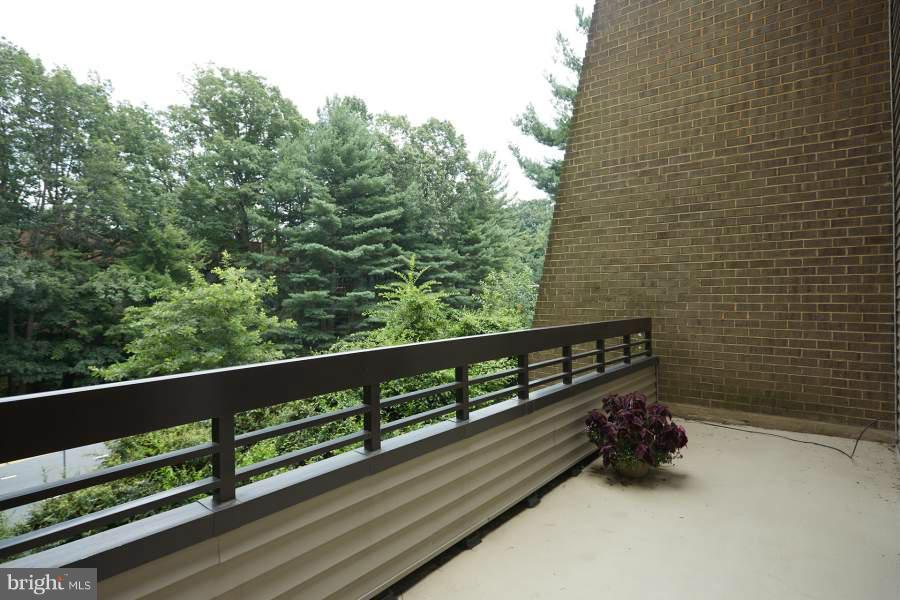 11602 Windbluff Court, Unit 8A1 Reston, VA 20191 - Photo 6 of 27 a view of a balcony with wooden fence and floor
