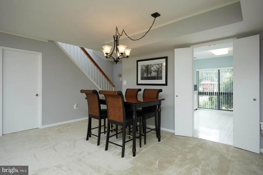 11602 Windbluff Court, Unit 8A1 Reston, VA 20191 - Photo 9 of 27 a view of a dining room with furniture and chandelier