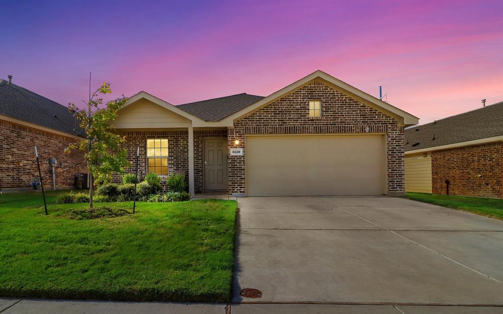 8228 High Garden Street Fort Worth, TX 76123 - Photo 1 of 23 a front view of a house with a yard and garage