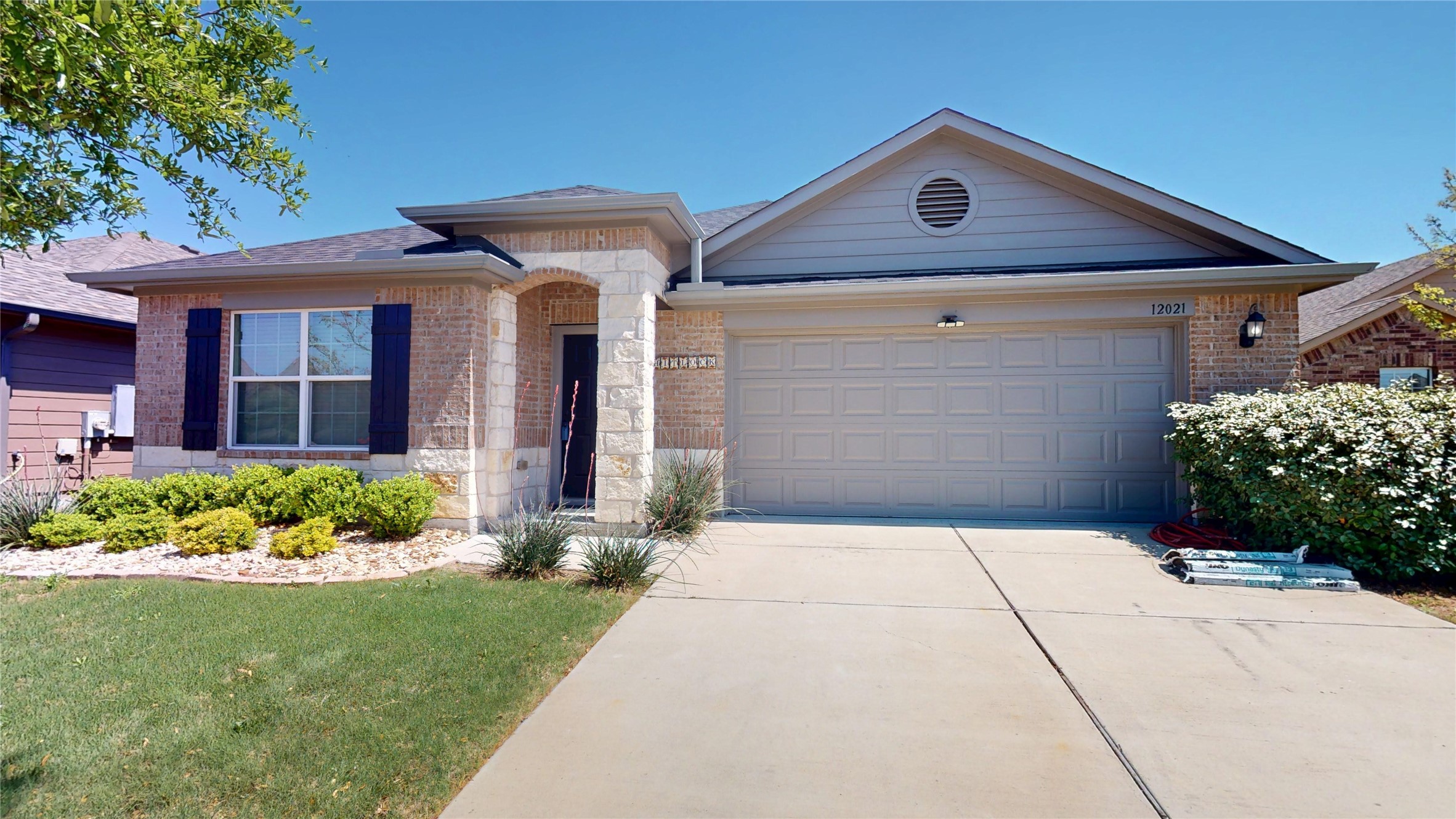 12021 Riparian Road Manor, TX 78653 - Photo 1 of 1 Great curb appeal with combination brick and stone as well as established lawn & planter beds