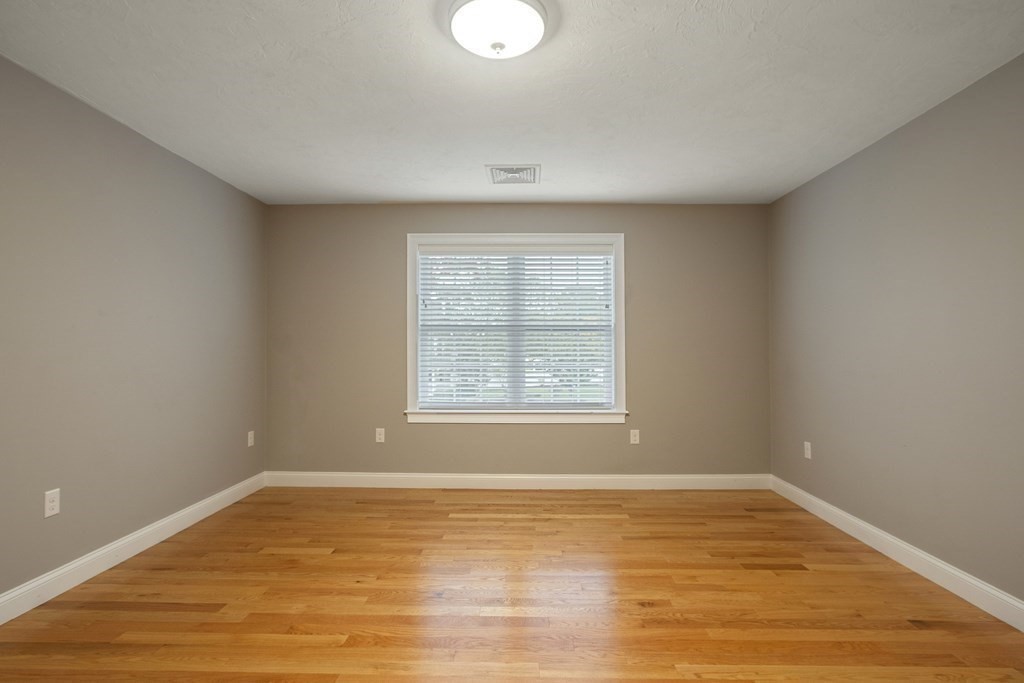 1 Applegate Road Medway, MA 02053 - Photo 17 of 41 a view of an empty room with wooden floor and a window