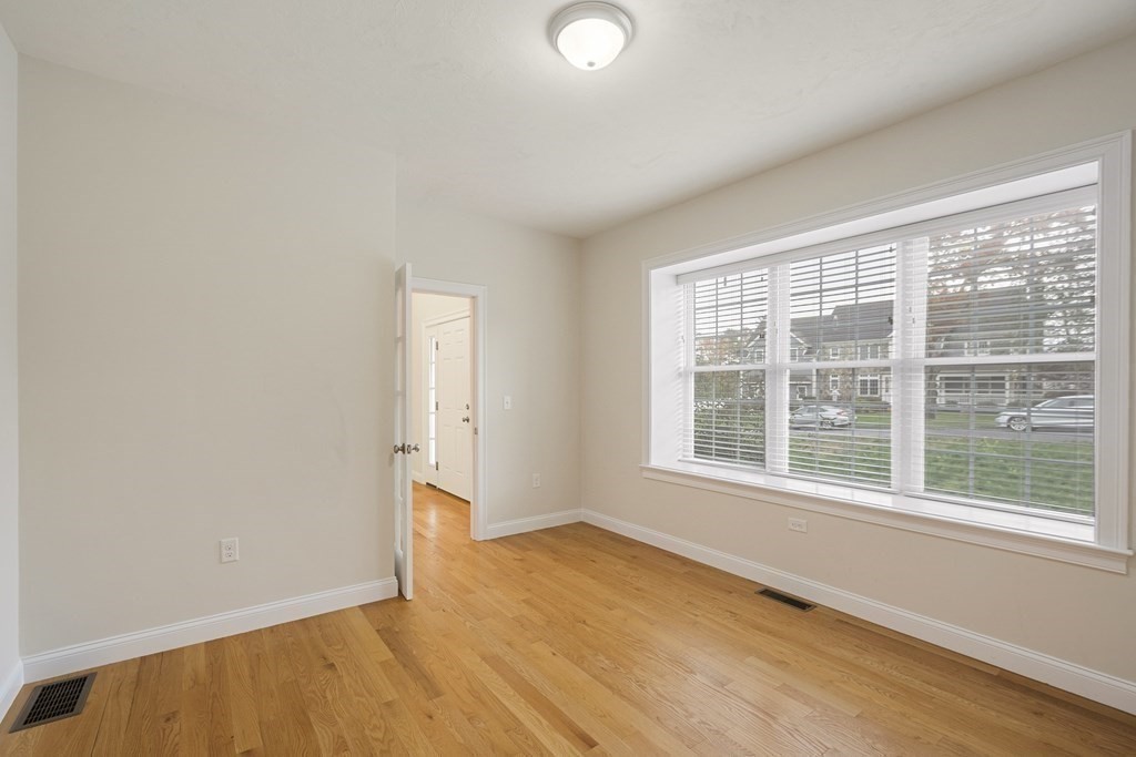 1 Applegate Road Medway, MA 02053 - Photo 20 of 41 a view of an empty room with wooden floor and a window