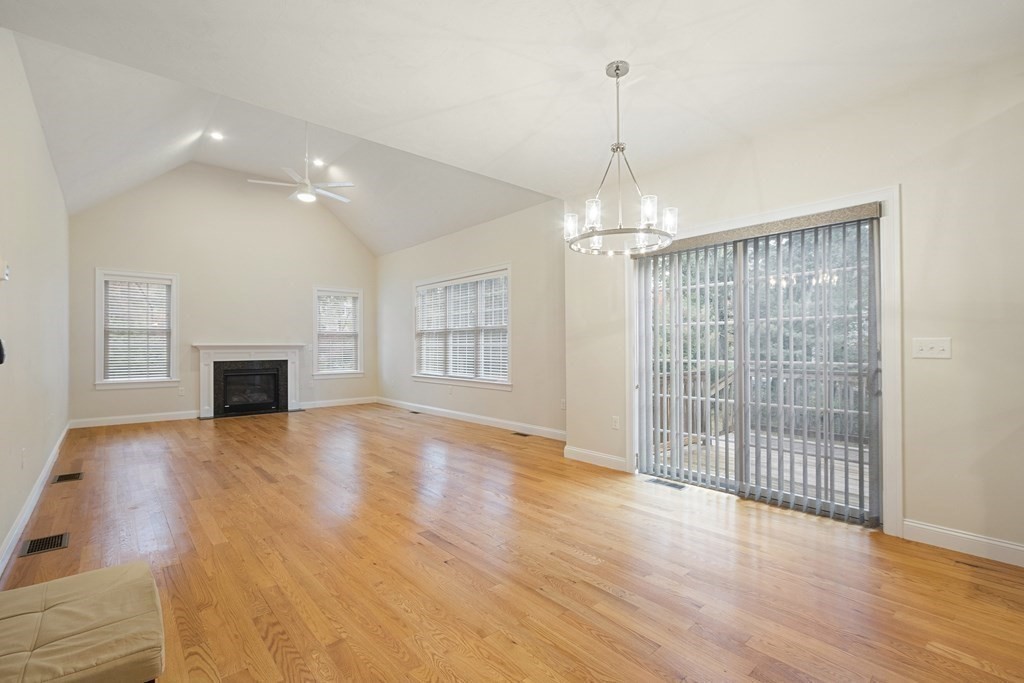 1 Applegate Road Medway, MA 02053 - Photo 9 of 41 an empty room with wooden floor and fireplace