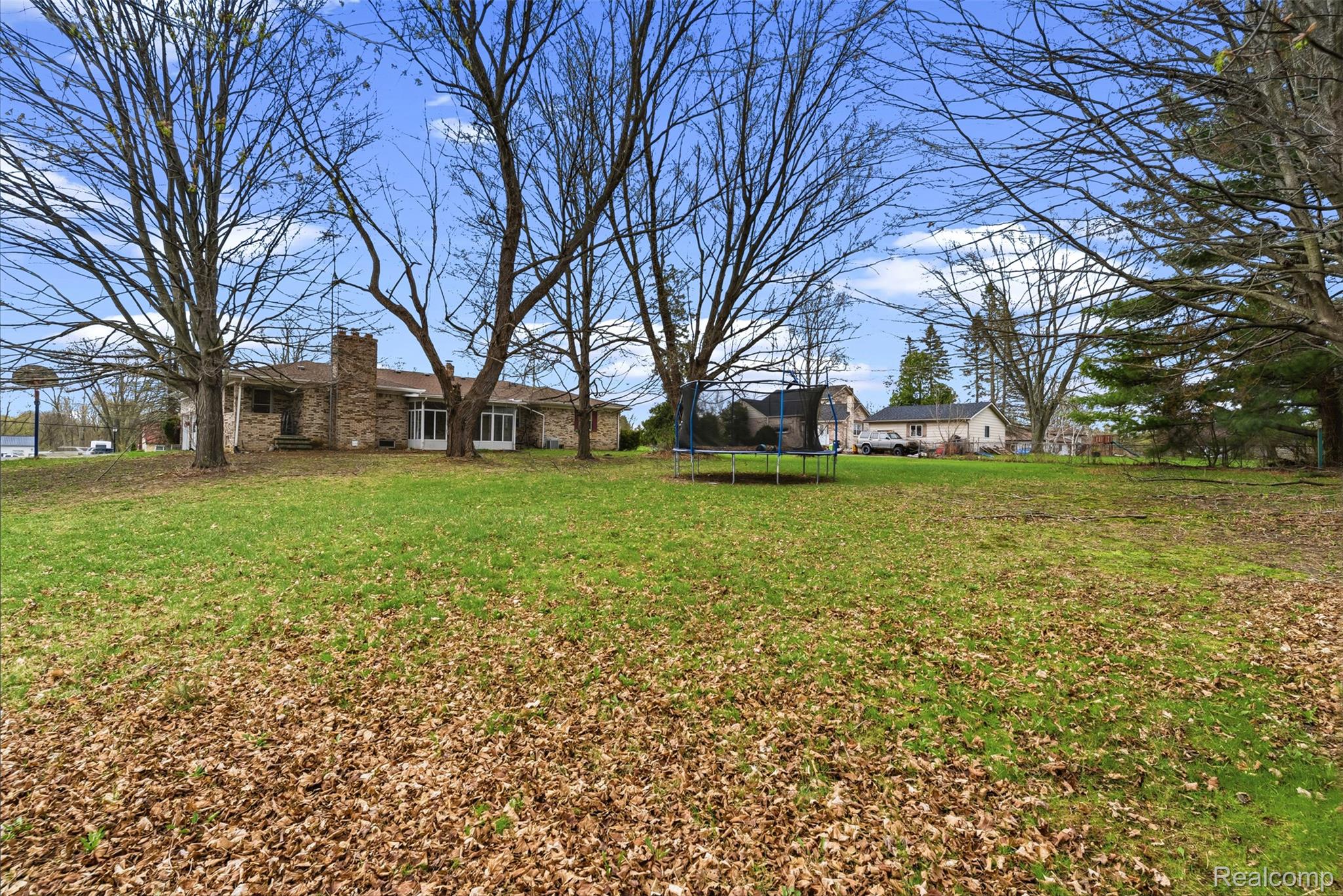 3432 South State Road Davison, MI 48423 - Photo 50 of 58 View of green lawn featuring a trampoline