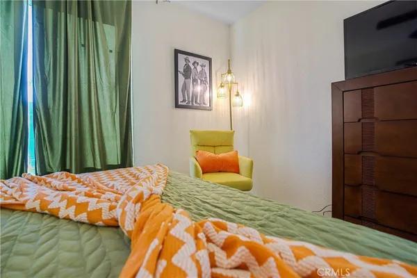 a bedroom with furniture and a chandelier
