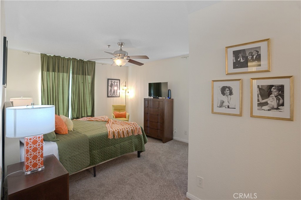 43376 Cook Street, Unit 125 Palm Desert, CA 92211 - Photo 19 of 45 a bedroom with furniture and a chandelier