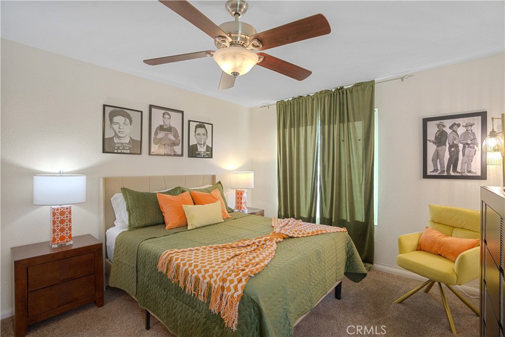 43376 Cook Street, Unit 125 Palm Desert, CA 92211 - Photo 20 of 45 a bedroom with a bed and a chandelier