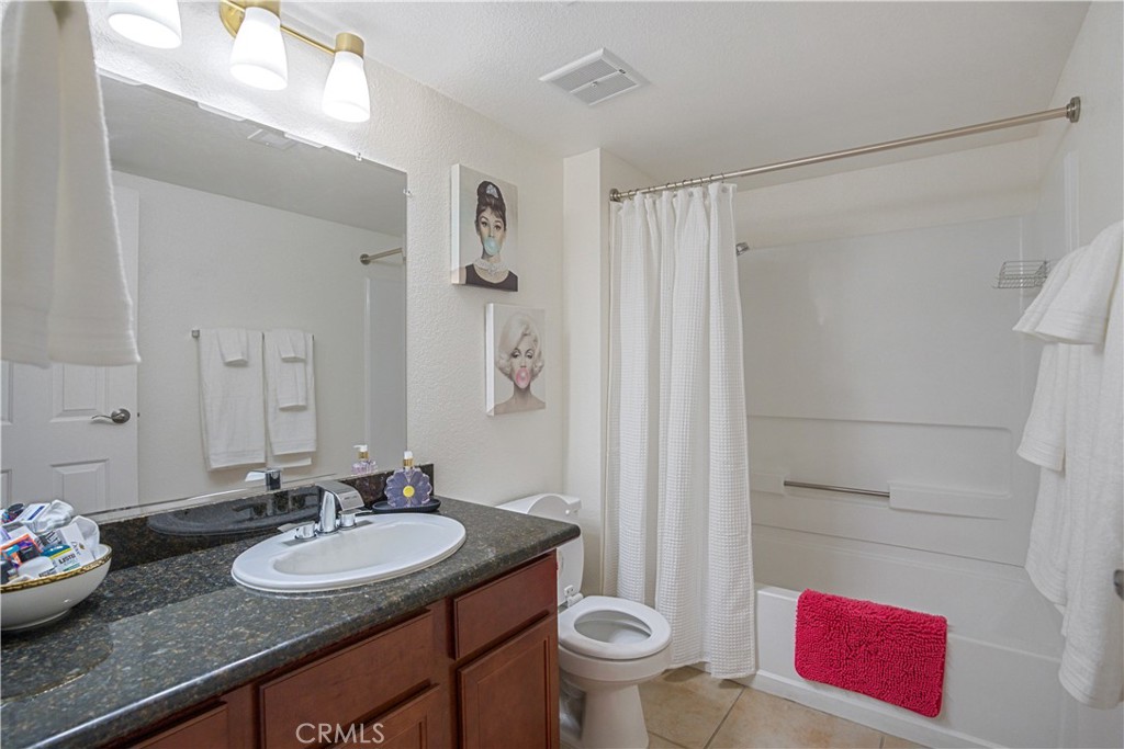43376 Cook Street, Unit 125 Palm Desert, CA 92211 - Photo 22 of 45 a bathroom with a granite countertop sink a toilet and a shower