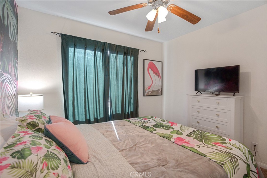 43376 Cook Street, Unit 125 Palm Desert, CA 92211 - Photo 24 of 45 a bedroom with a bed and a flat screen tv
