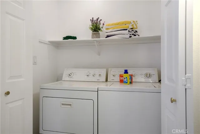 a kitchen with a refrigerator stove and white cabinets