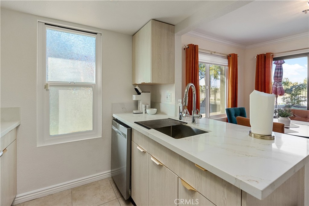 43376 Cook Street, Unit 125 Palm Desert, CA 92211 - Photo 29 of 45 a kitchen with a sink and a refrigerator