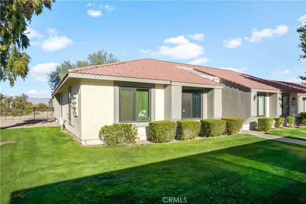 a front view of a house with a yard table and chairs