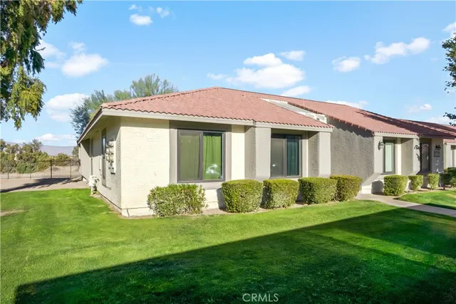 a front view of a house with a yard table and chairs