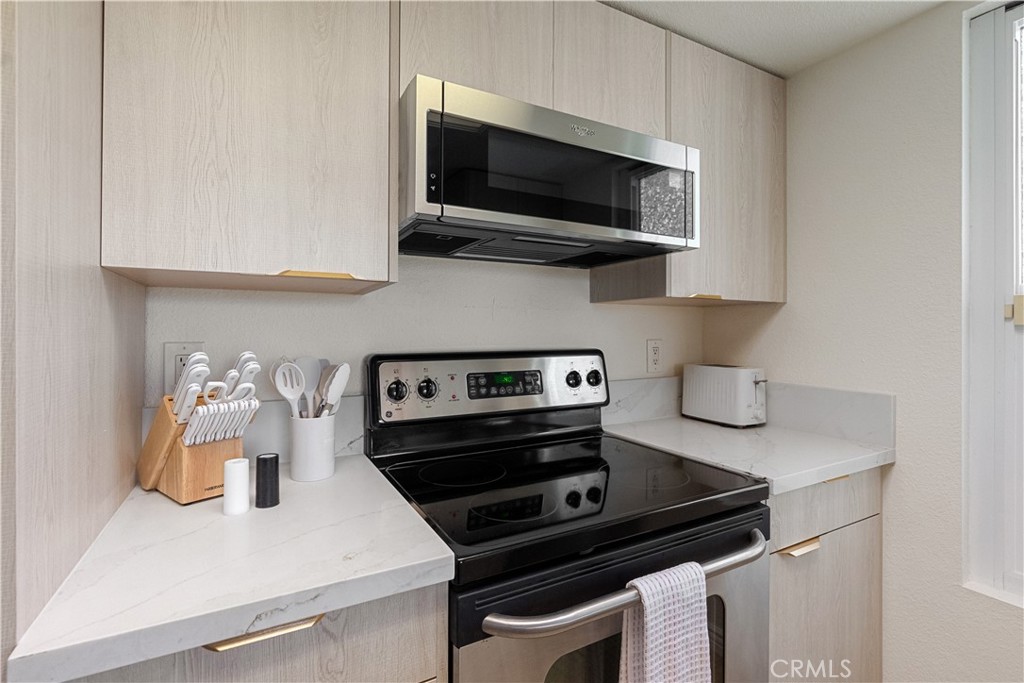 43376 Cook Street, Unit 125 Palm Desert, CA 92211 - Photo 44 of 45 a kitchen with a stove and a microwave