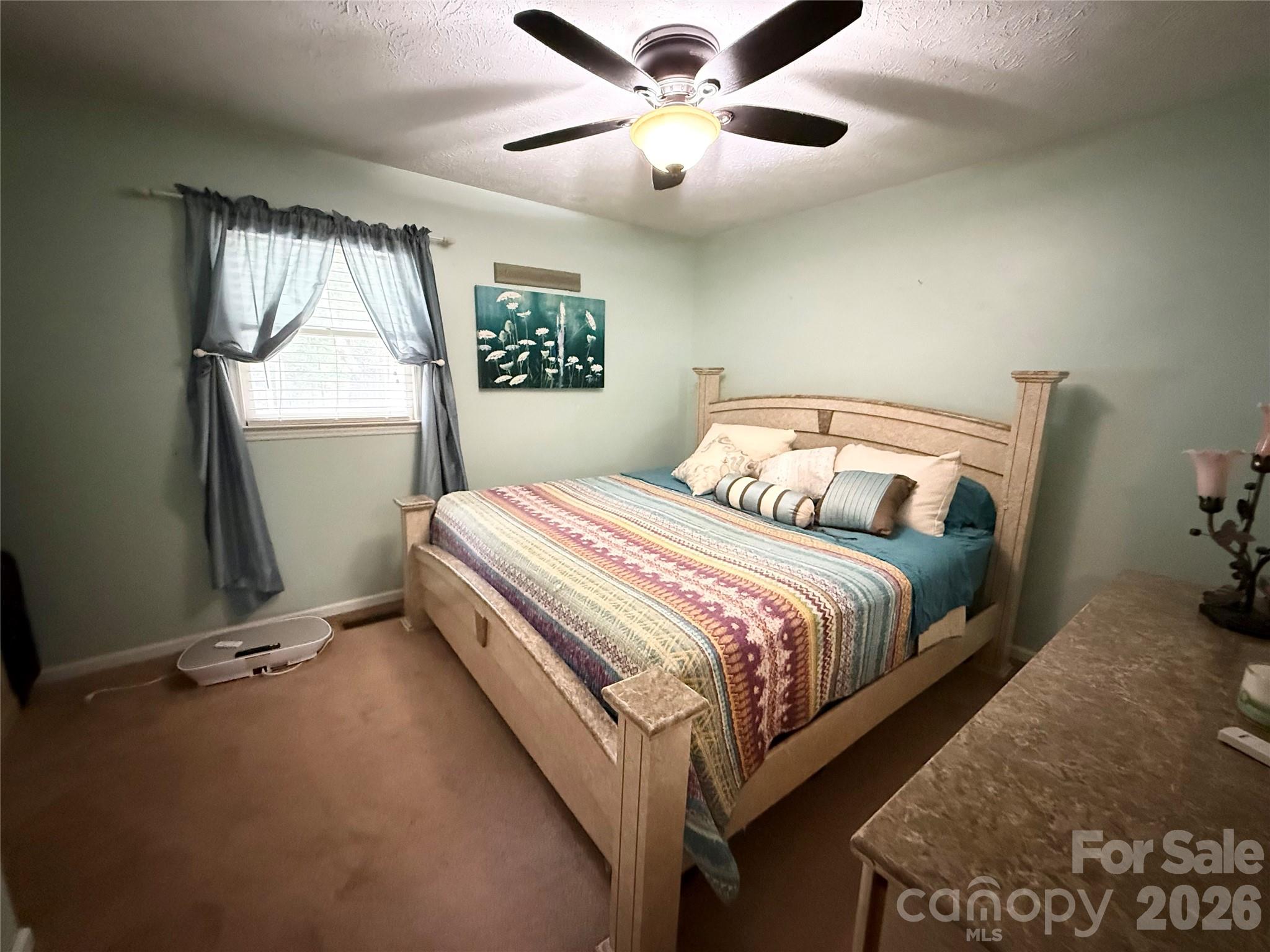 580 Legion Road Lenoir, NC 28645 - Photo 9 of 22 a bedroom with a bed and a large window